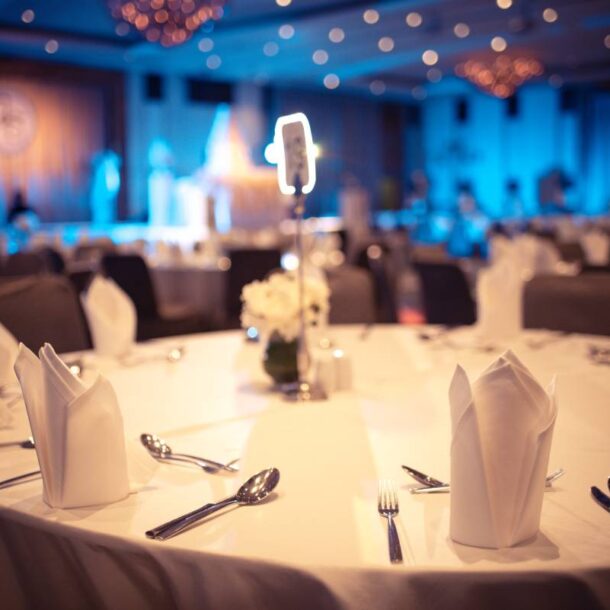 Banquet hall near Southfield, MI, with a circular table with fancy napkins, silverware, and tablecloth at The Atrium Event Space near Southfield, Michigan (MI)