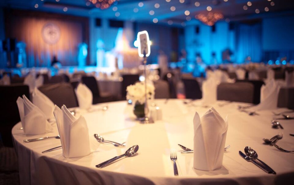Banquet hall near Southfield, MI, with a circular table with fancy napkins, silverware, and tablecloth at The Atrium Event Space near Southfield, Michigan (MI)