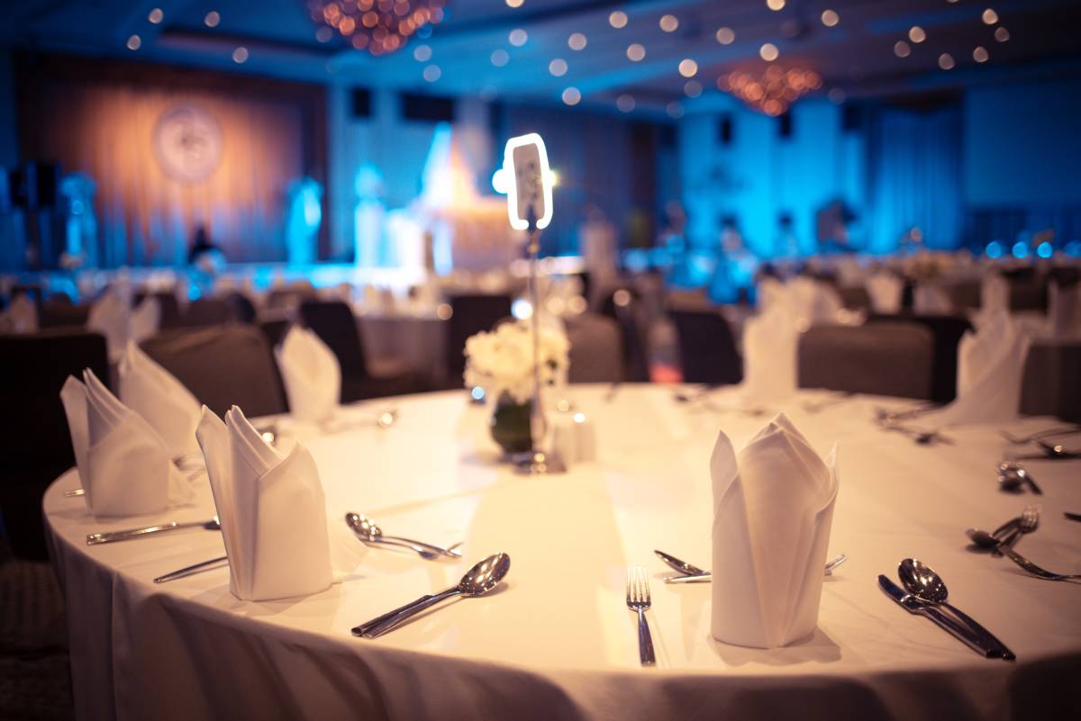 Banquet hall near Southfield, MI, with a circular table with fancy napkins, silverware, and tablecloth at The Atrium Event Space near Southfield, Michigan (MI)