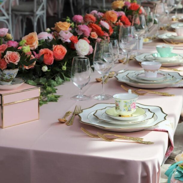 A tablescape with florals, vintage place settings, and dainty teacups for a wedding shower at The Atrium Event Space near Southfield, Michigan (MI)