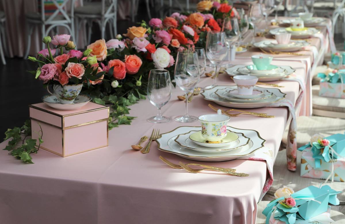 A tablescape with florals, vintage place settings, and dainty teacups for a wedding shower at The Atrium Event Space near Southfield, Michigan (MI)