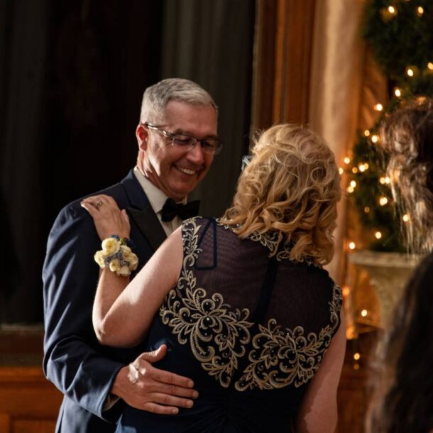 A happy older couple dancing together at their perfectly planned anniversary party near Metro Detroit