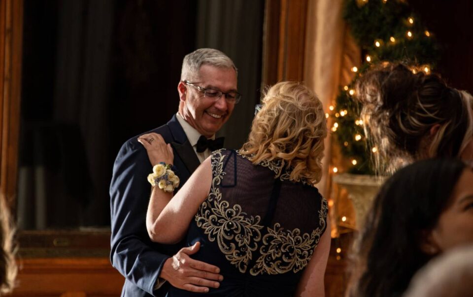 A happy older couple dancing together at their perfectly planned anniversary party near Metro Detroit