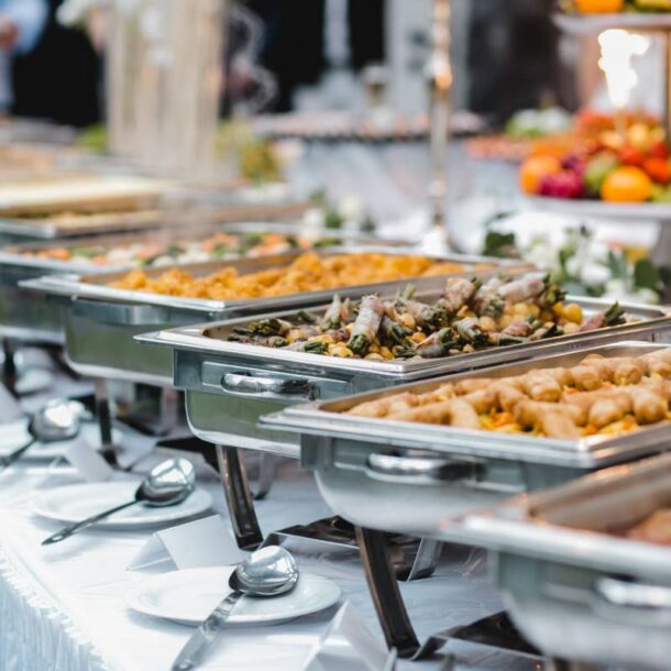 A table featuring warming platters of food for an event at a venue with catering packages near Southfield, MI