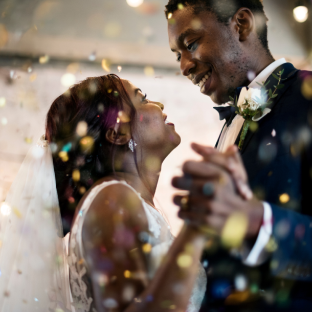 Beautiful bride and groom sharing a dance together with confetti on their wedding day