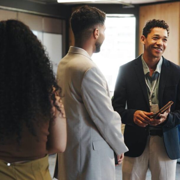Professionals networking together at a job fair or career expo at a venue near Detroit, MI