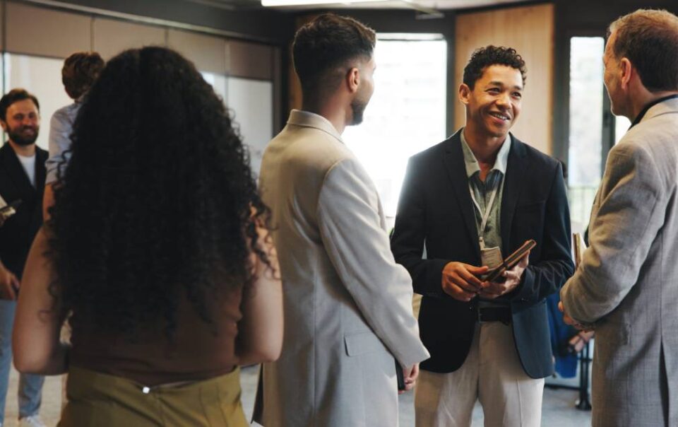 Professionals networking together at a job fair or career expo at a venue near Detroit, MI